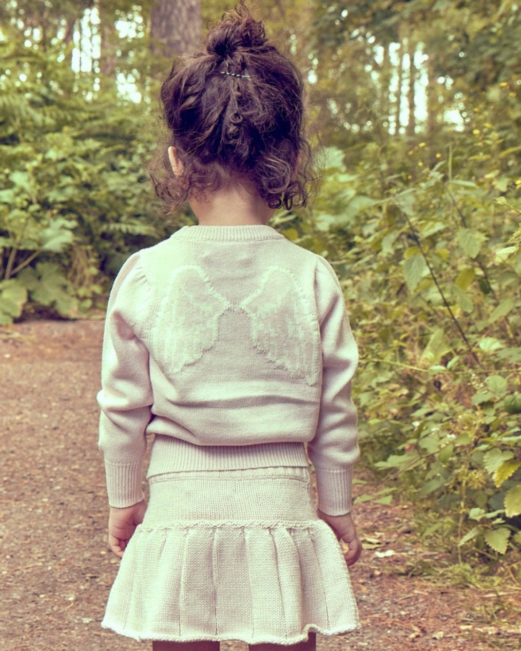 Child in the MIKA & MILO Angel Jumper photographed against a soft neutral backdrop