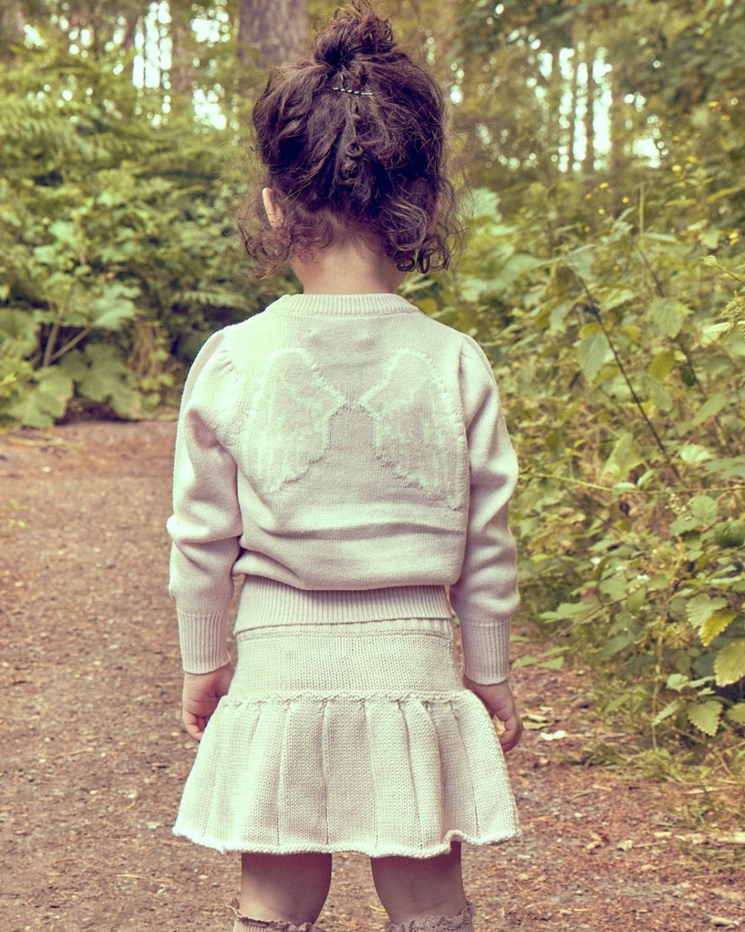Toddler wearing the Baby Angel Jumper from MIKA & MILO in soft natural light