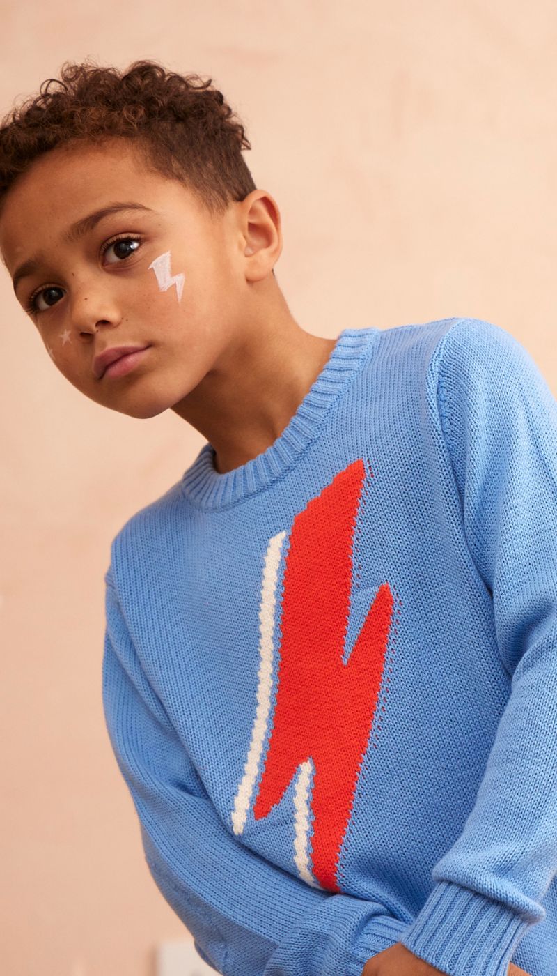 Side view of a child in the azure Lightning Bolt Jumper from MIKA & MILO