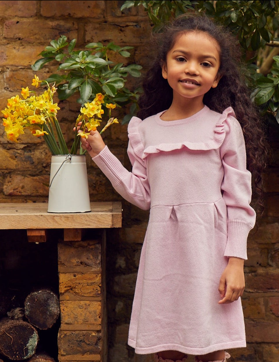 This lovely dress has gentle puff sleeves and a stylish ruffle down and across the chest. It also comes with pleats at the waistline for added femininity and is bright pink to chase away those winter blues. Made with the softest cashmere/ merino blend from Inner Mongolia, it will keep your Little One stylish and warm all winter long.