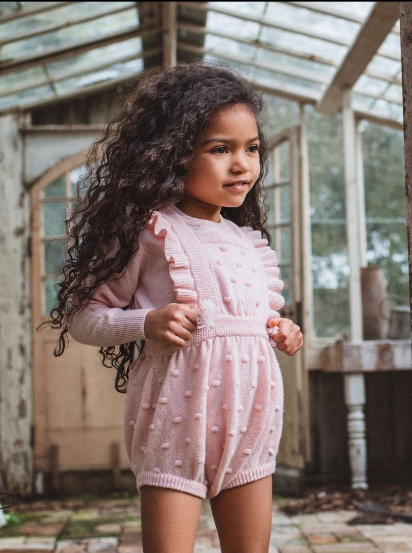 This stylish 4 ply Ruffled Bobble Romper comes with lots and lots of Bobbles. After all, who doesn't love bobbles. It makes a fun addition to any winter wardrobe and comes with 3 buttons holes on the straps so that they can be extended as your Little One grows. Made with the softest cashmere/merino blend from Inner Mongolia, it will keep your Little One cosy and warm all winter long. Team it up with a cosy jumper underneath and a thick pair of tights.