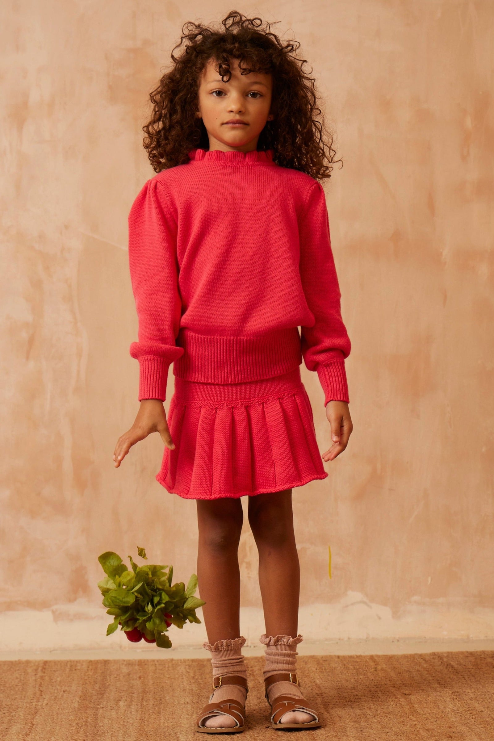 Side view of the raspberry MIKA & MILO Ruffled Collared Jumper showing the ribbed waistband