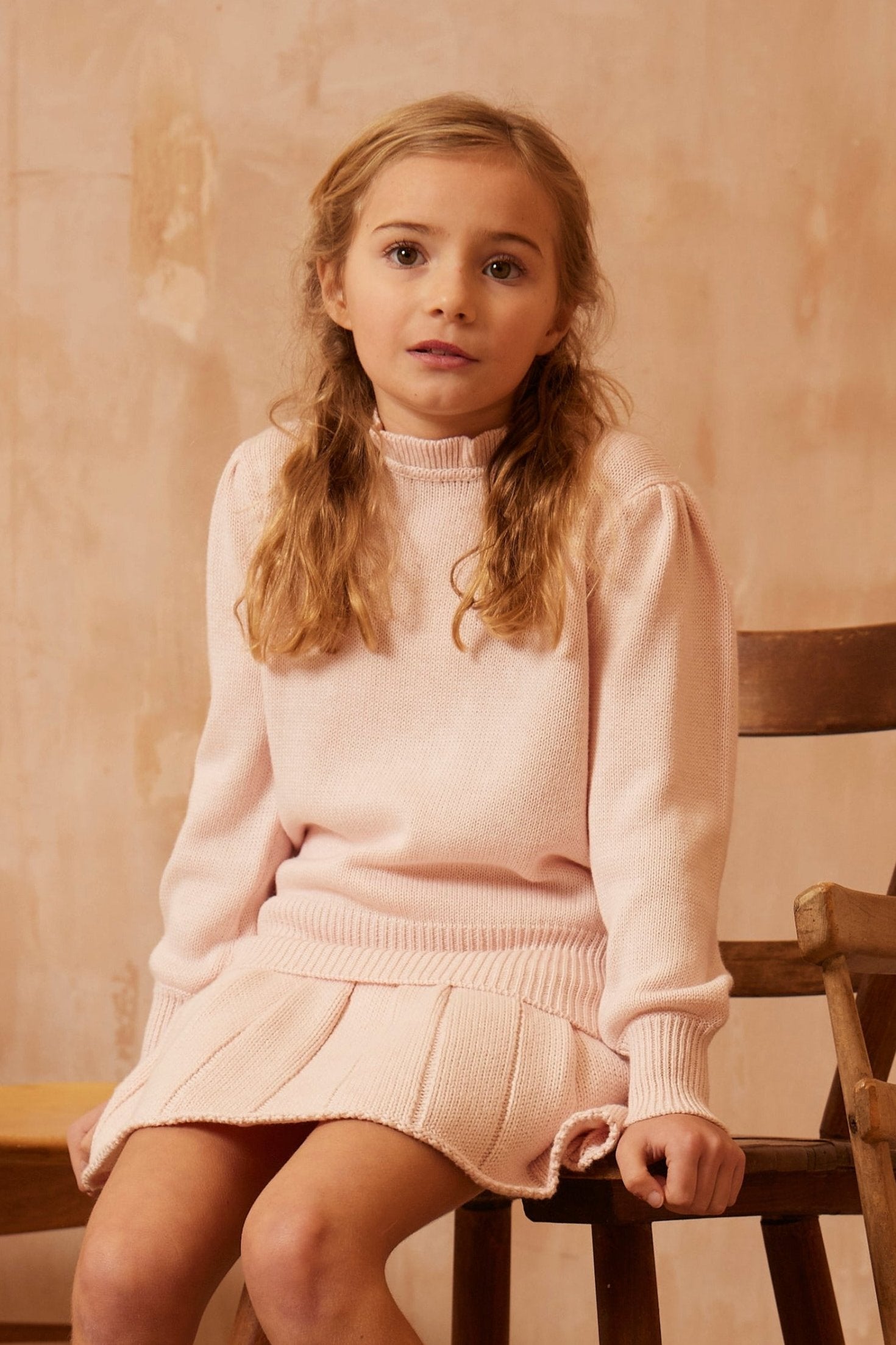 Young girl in a blush Ruffled Collared Jumper from MIKA & MILO, soft organic cotton and cashmere with delicate collar detail