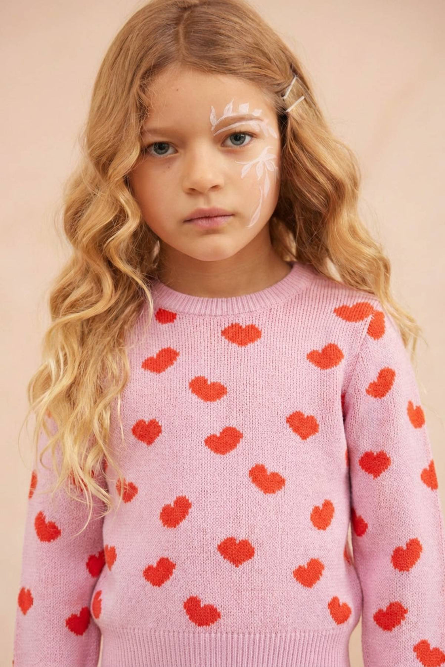 Young girl in the bubble gum Love Hearts Jumper from MIKA & MILO, organic cotton and cashmere with jacquard heart knit