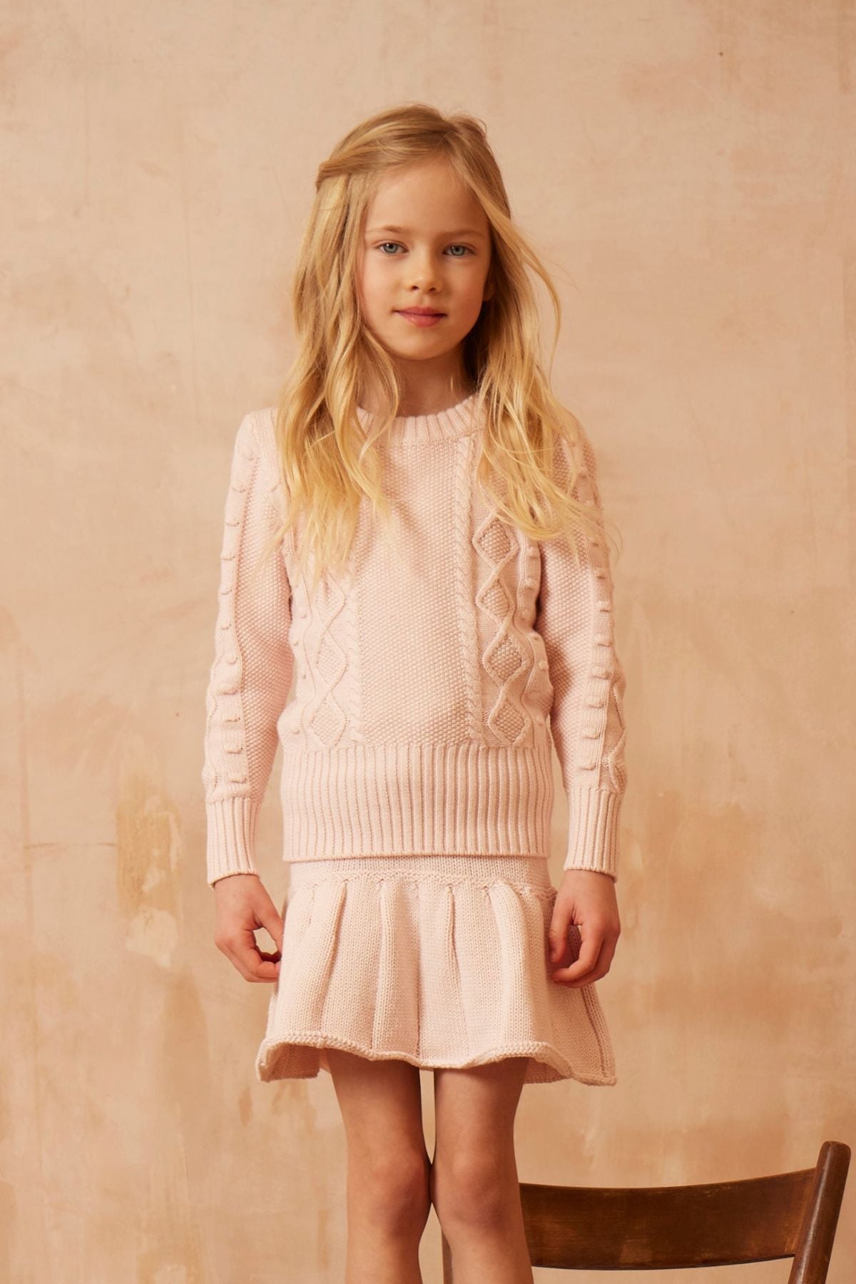 Side view of the blush Cable Popcorn Jumper from MIKA & MILO showing the ribbed waistband