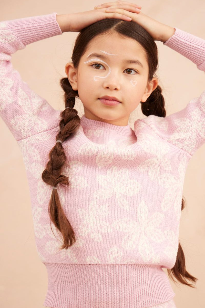 Young girl in a bubble gum pink Chestnut Leaves Jumper from MIKA & MILO, jacquard knit in organic cotton and cashmere