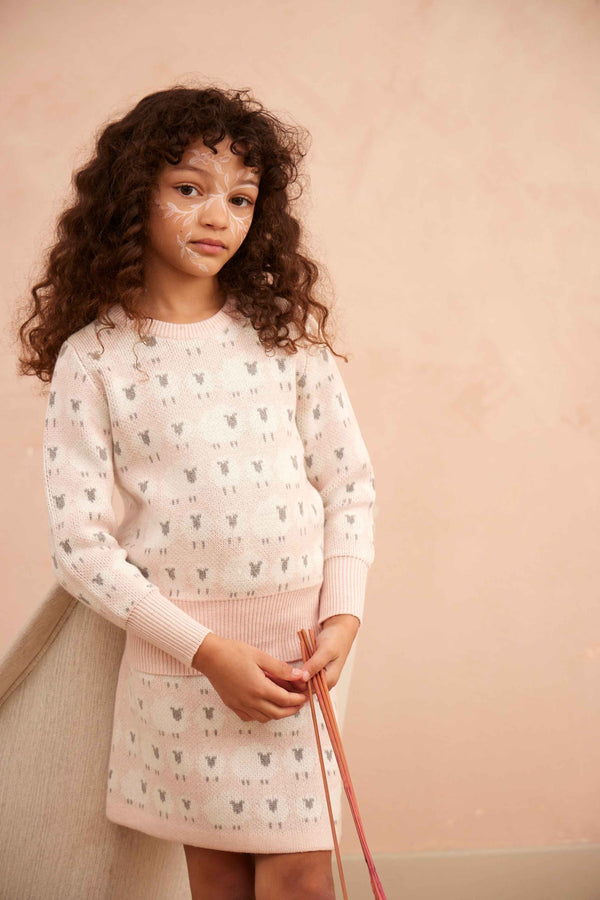 Girl in the blush Little Bo Peep Pencil Skirt from MIKA & MILO with jacquard sheep motif