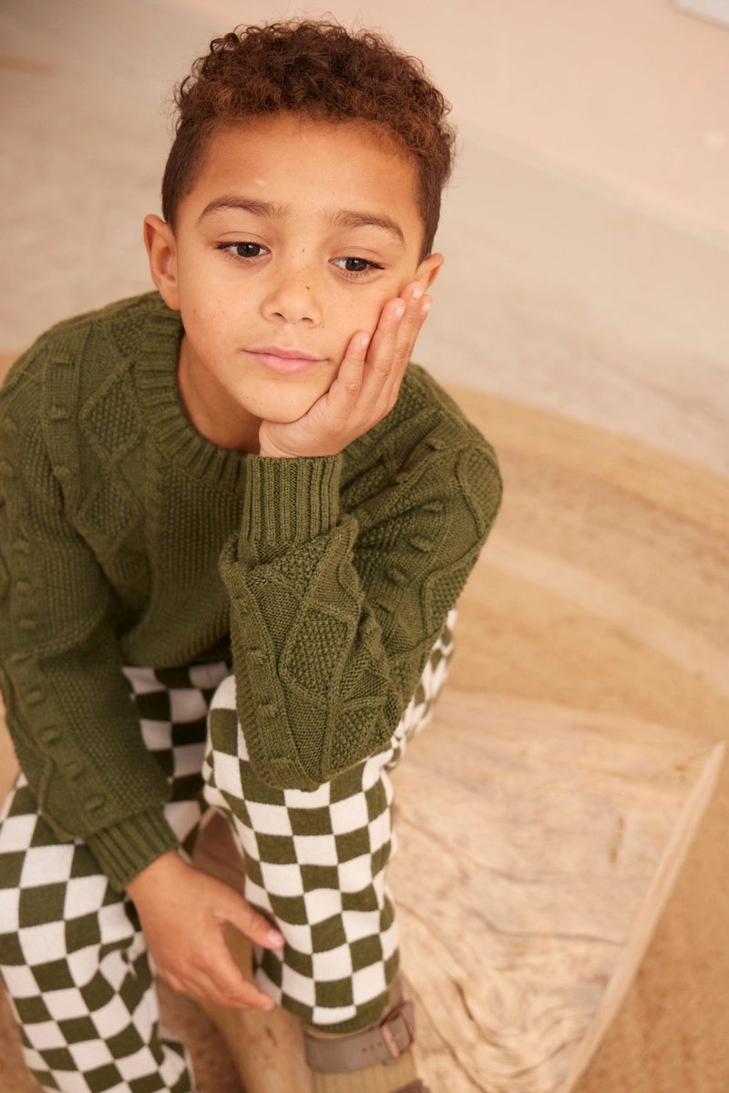 Boy in the avocado green Cable Popcorn Jumper from MIKA & MILO, heritage knit in organic cotton and cashmere