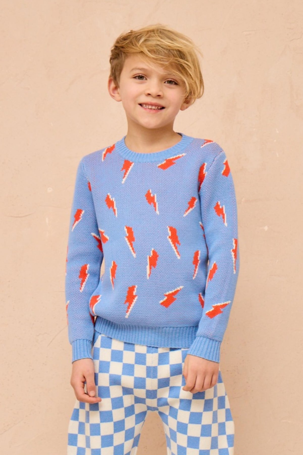 Boy wearing the MIKA & MILO Bolt Storm Jumper in azure blue
