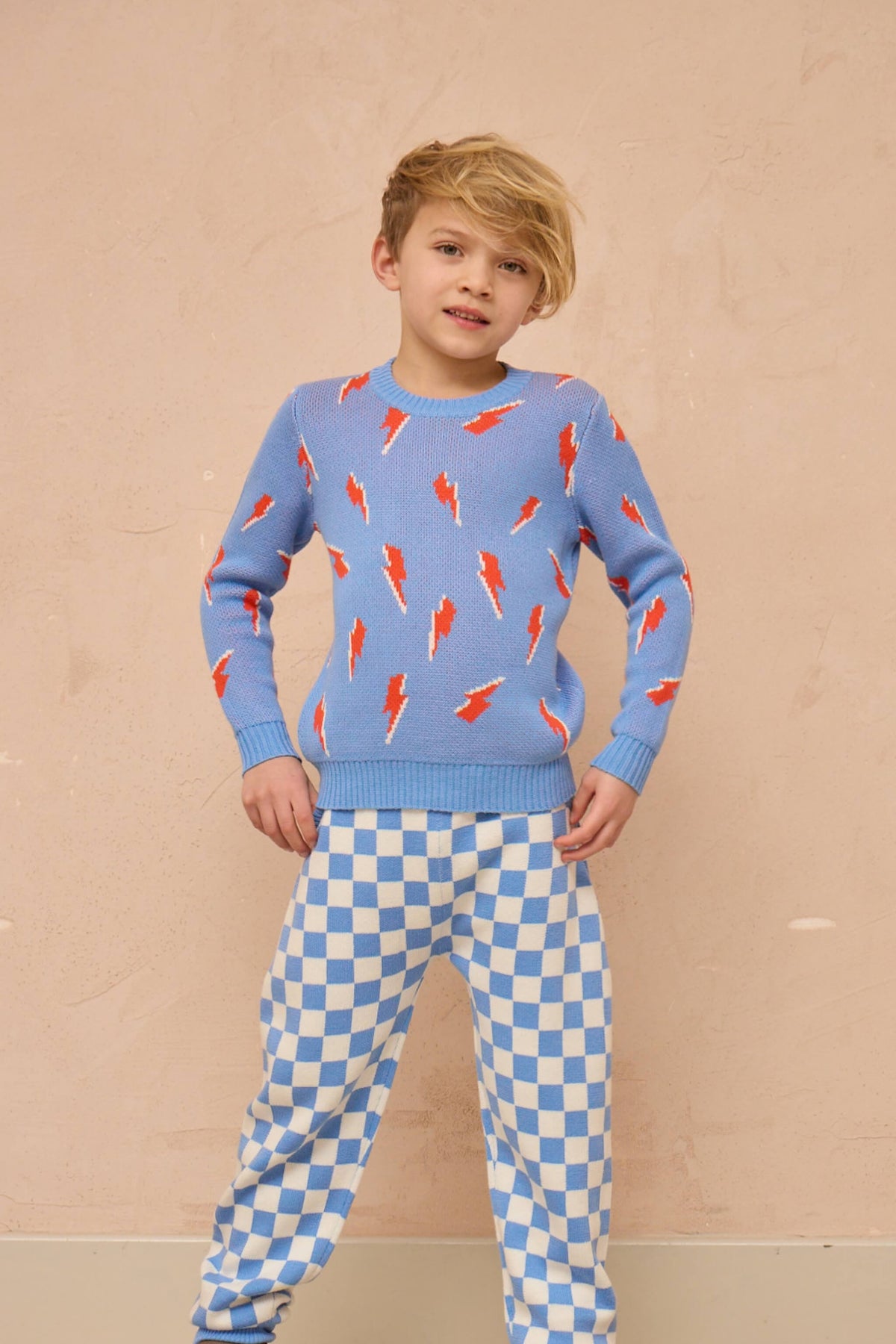 Side view of a boy in the Bolt Storm Jumper in azure blue
