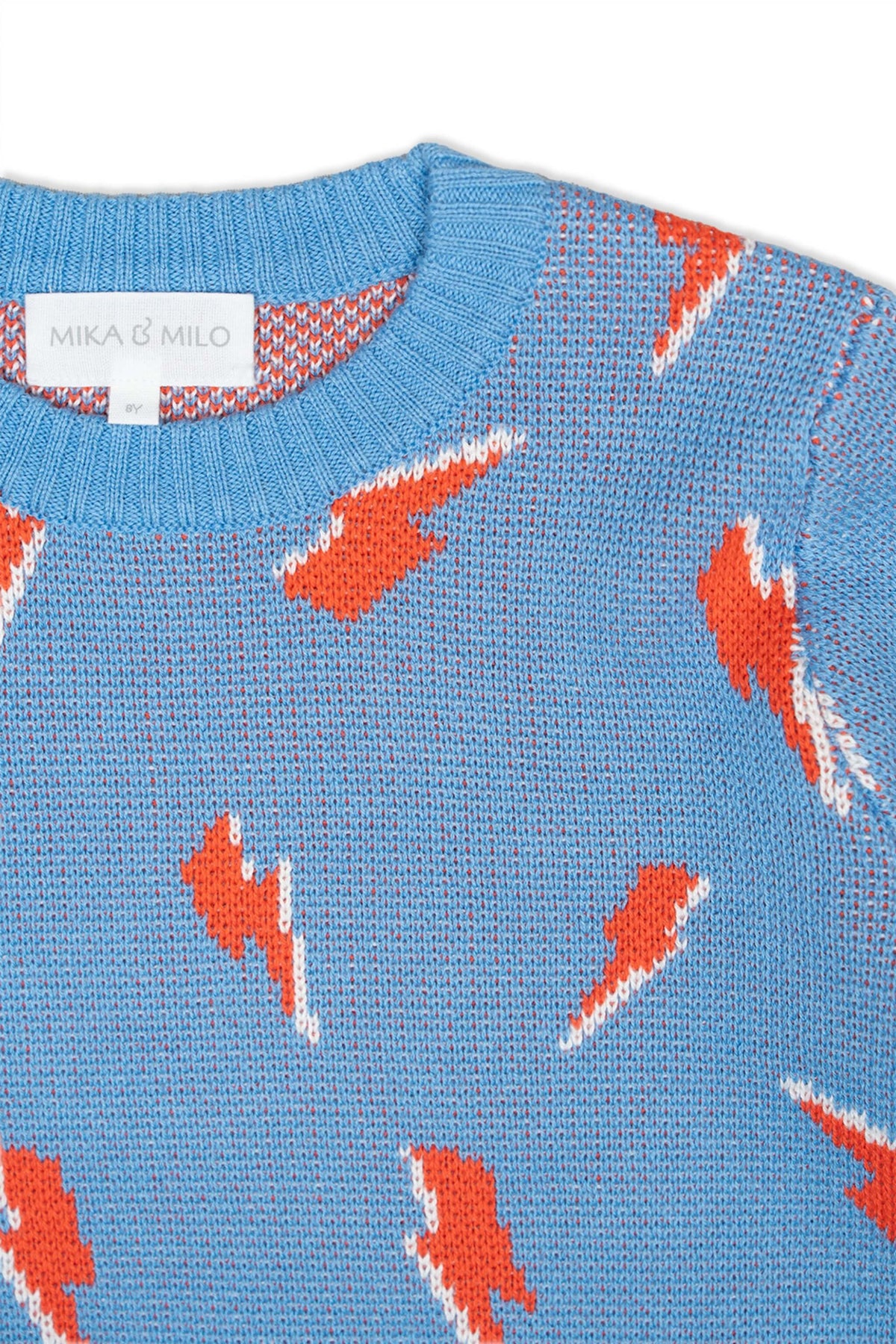 Close-up of the jacquard-knit lightning bolts on the azure blue jumper