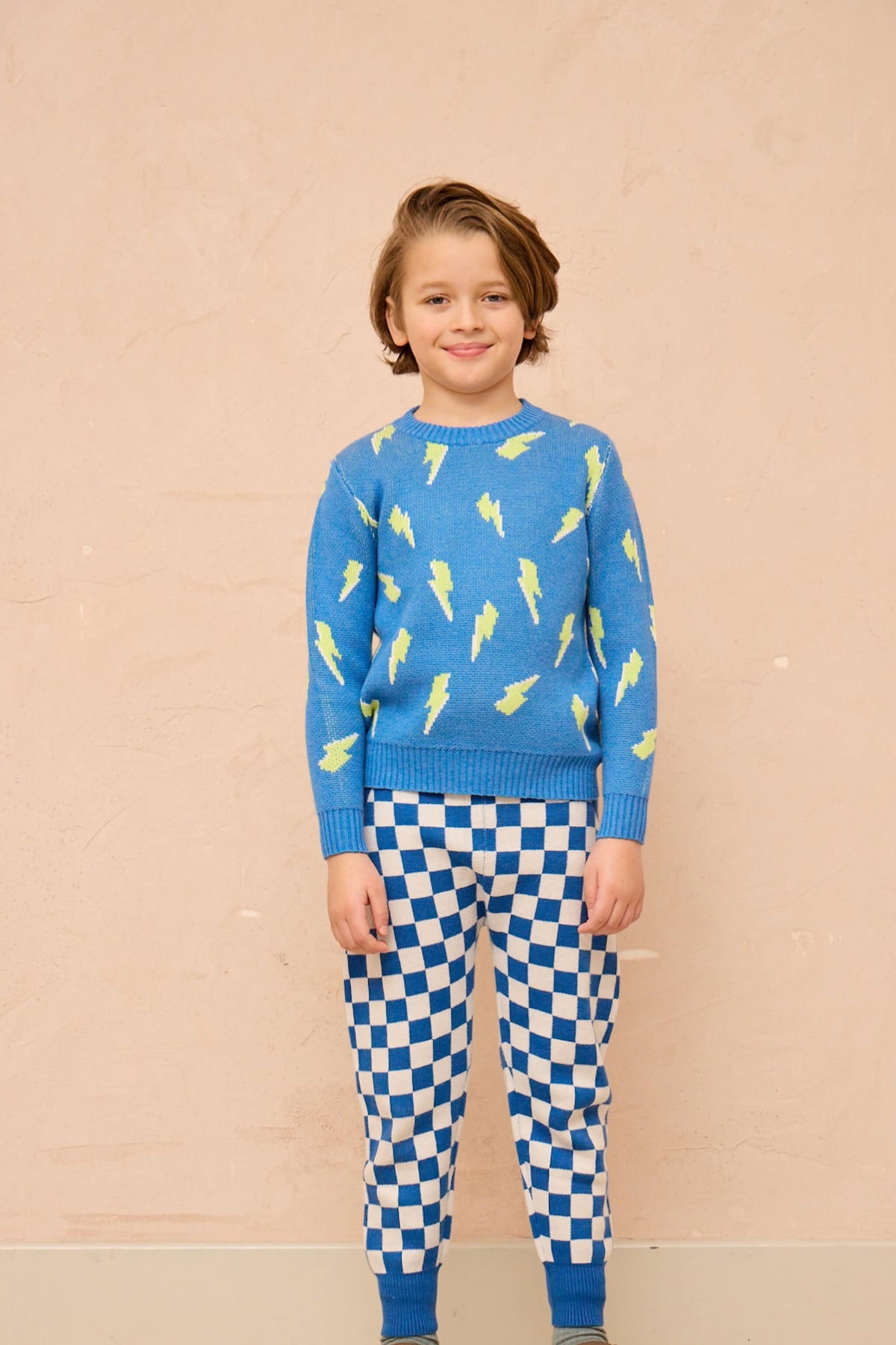 Side view of a boy in the Bolt Storm Jumper in hussar blue
