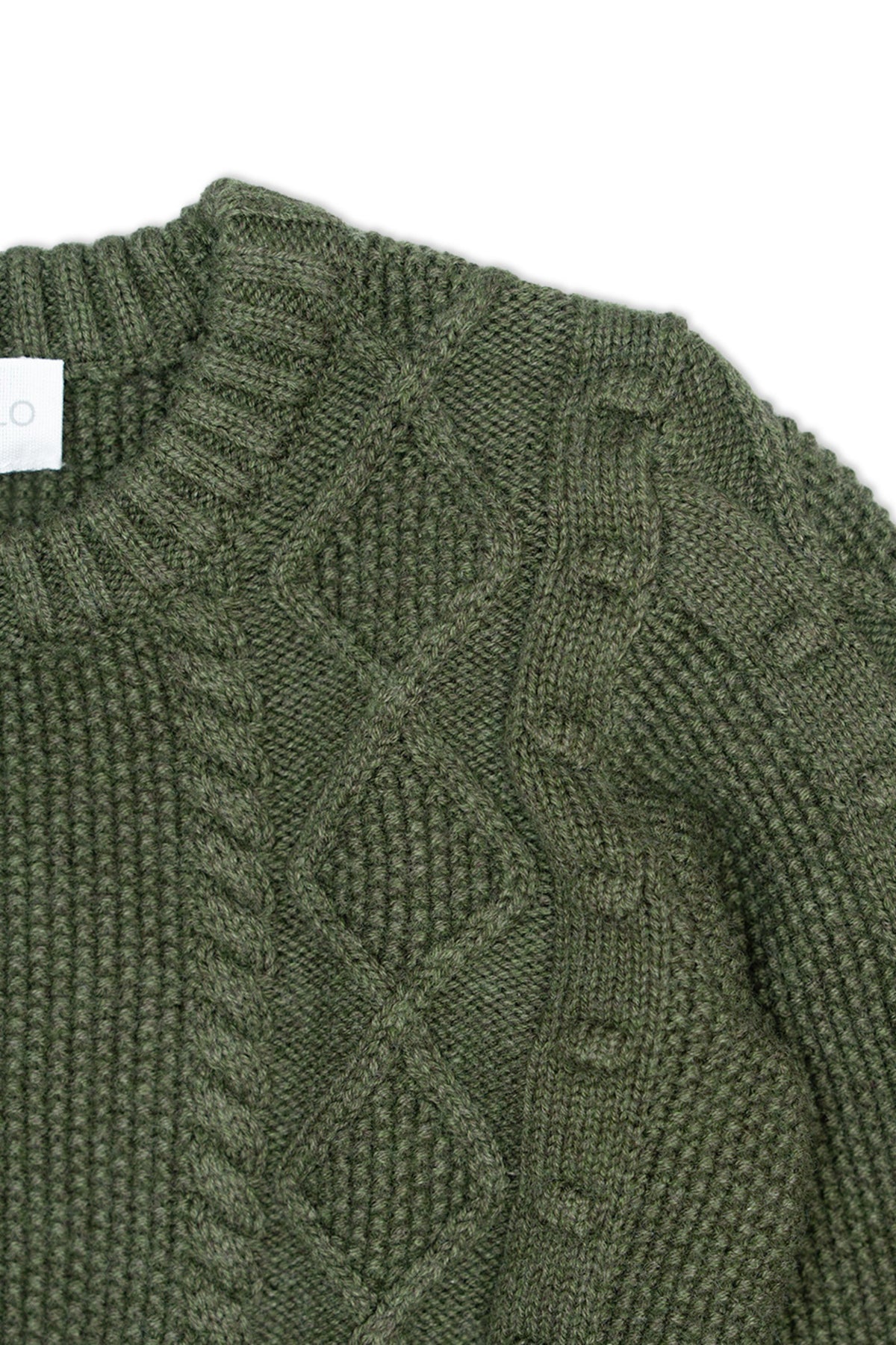 Close-up of the cable, moss stitch and popcorn bobbles on the avocado green jumper
