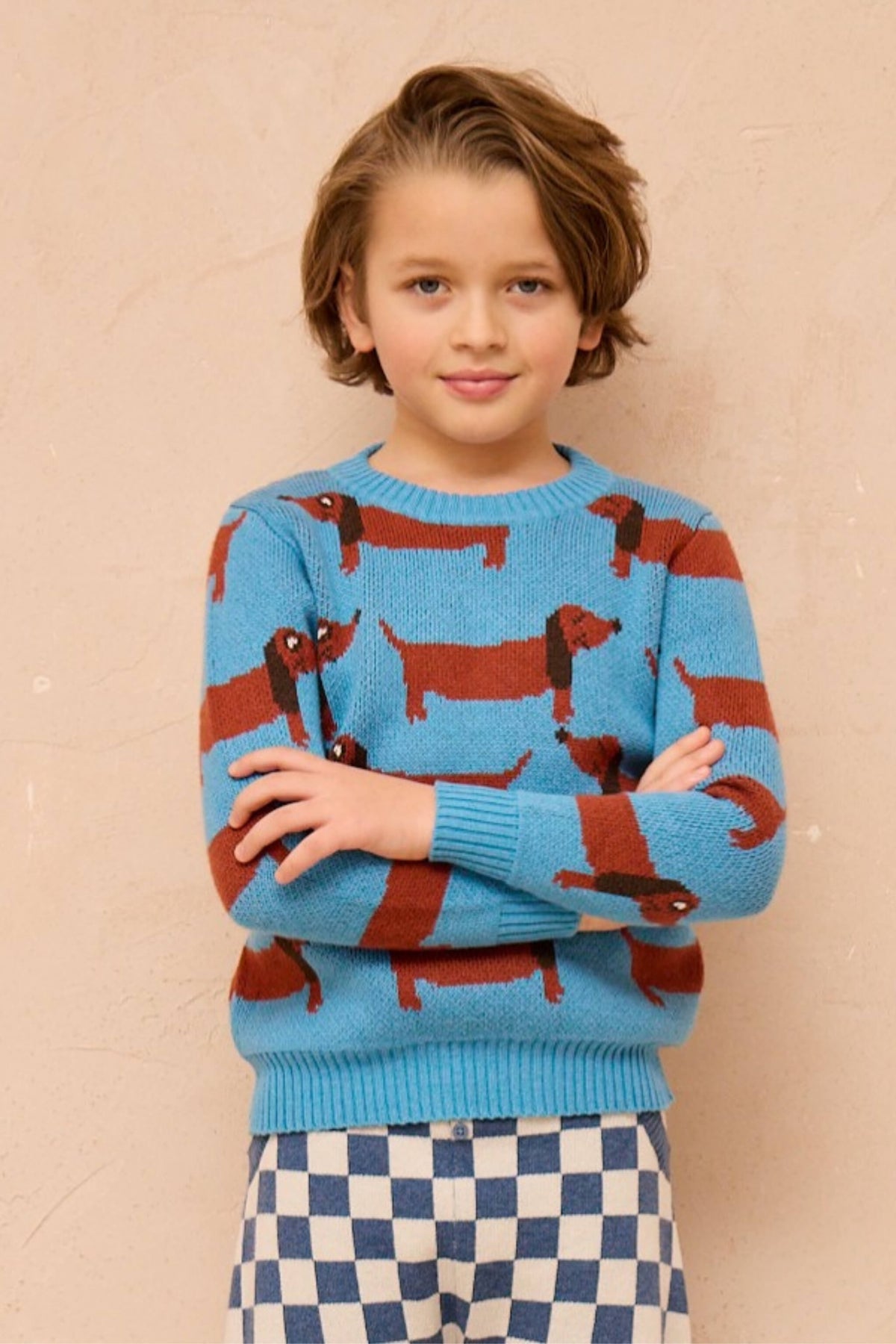 Side view of a boy in the Dachshund Jumper in Iceland blue