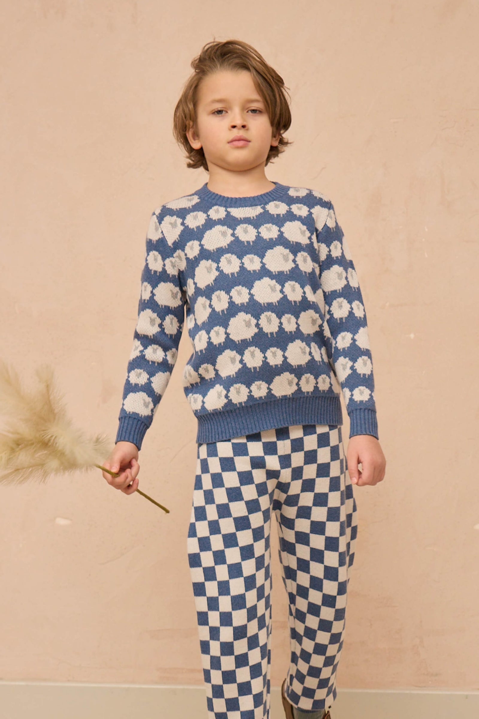 Boy wearing the MIKA & MILO Flock of Sheep Jumper in bluestone blue