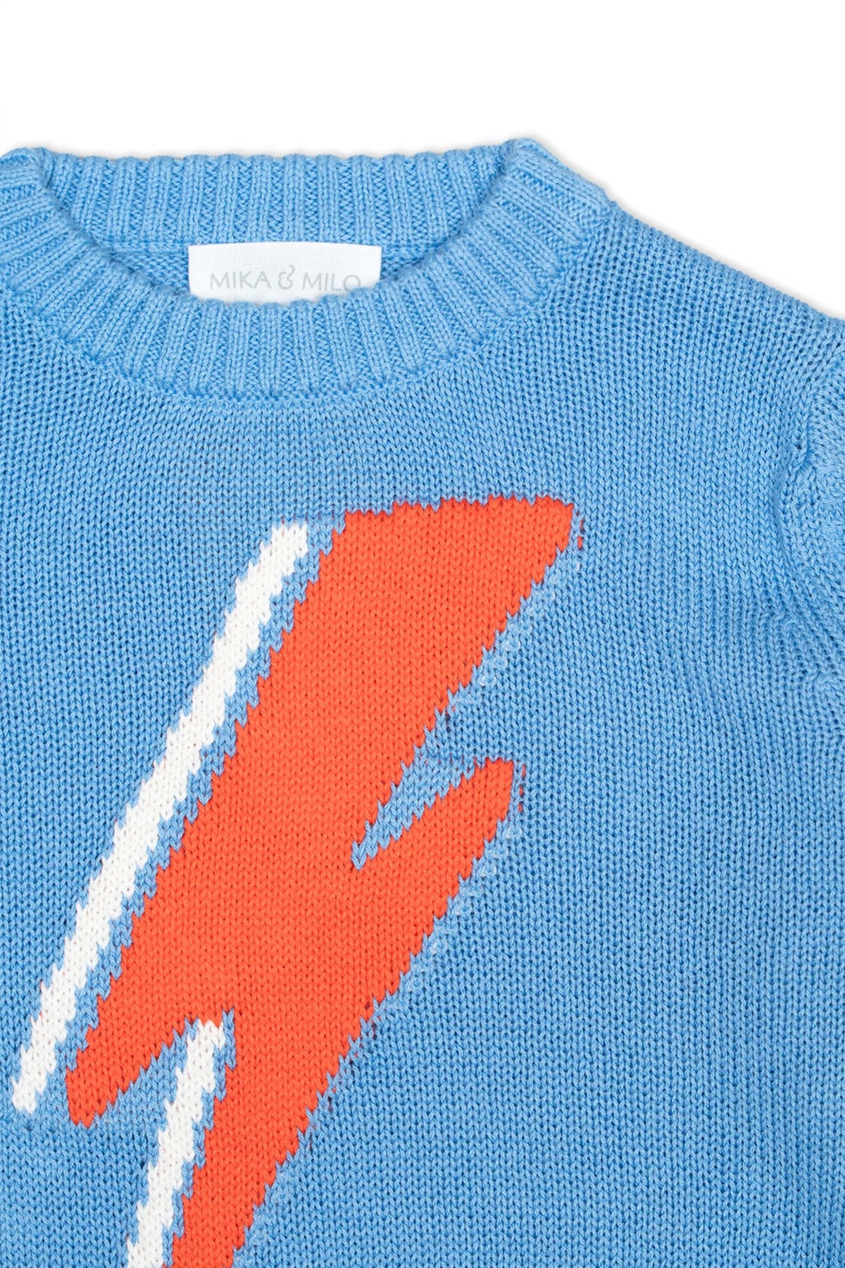 Close-up of the intarsia lightning bolt on the azure blue jumper