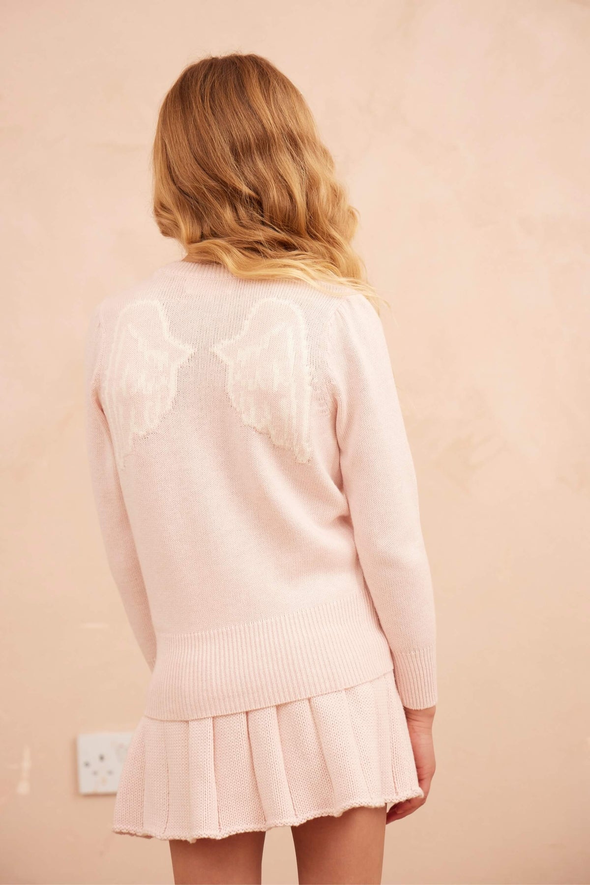 Girl wearing the MIKA & MILO Angel Wings Jumper in blush pink