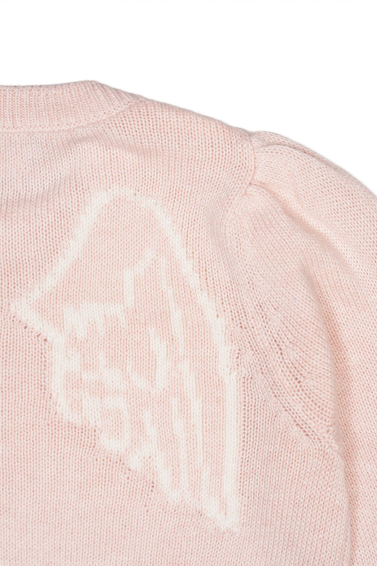 Close-up of the intarsia angel motif on the blush pink jumper