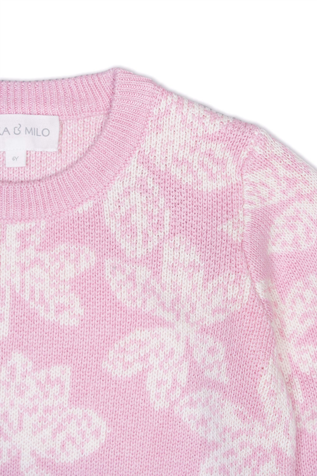 Close-up of the jacquard-knit chestnut leaves on the bubble gum pink jumper