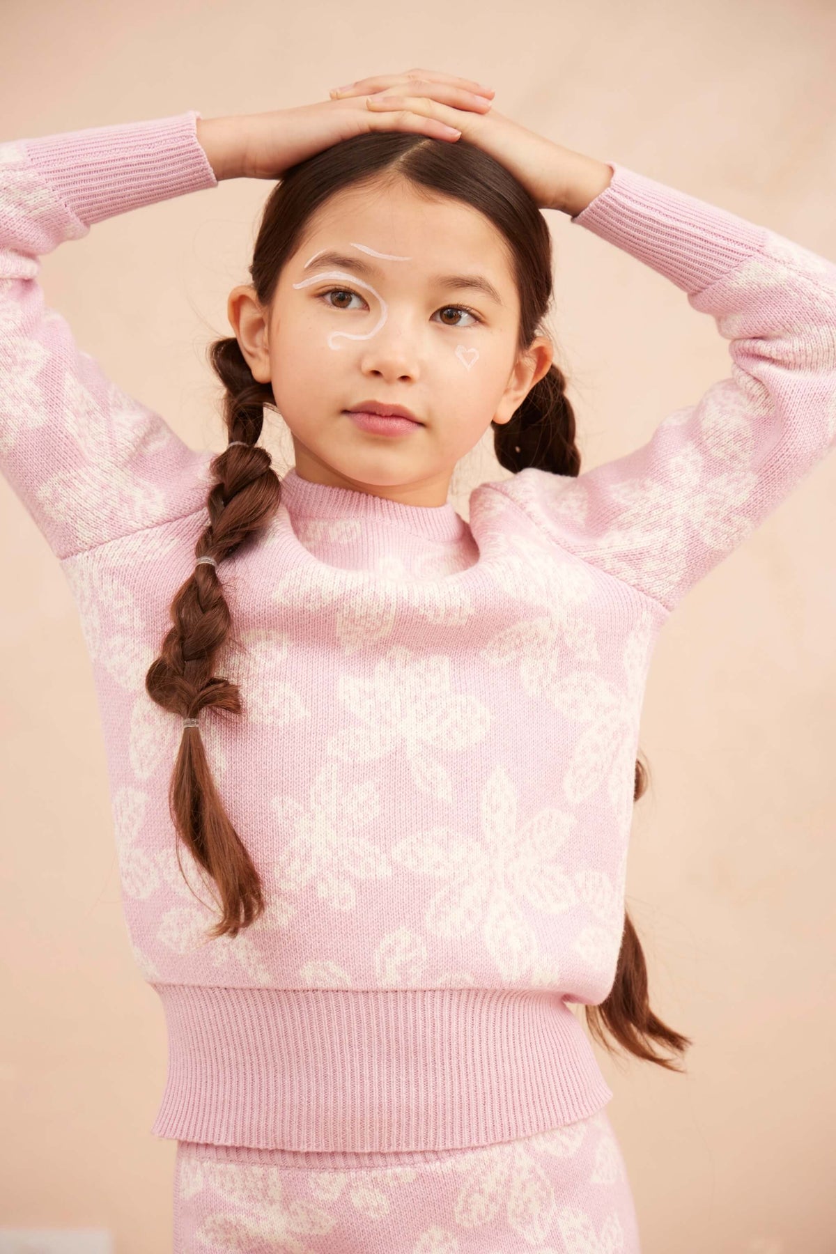 Girl wearing the Chestnut Leaves Jumper in bubble gum pink