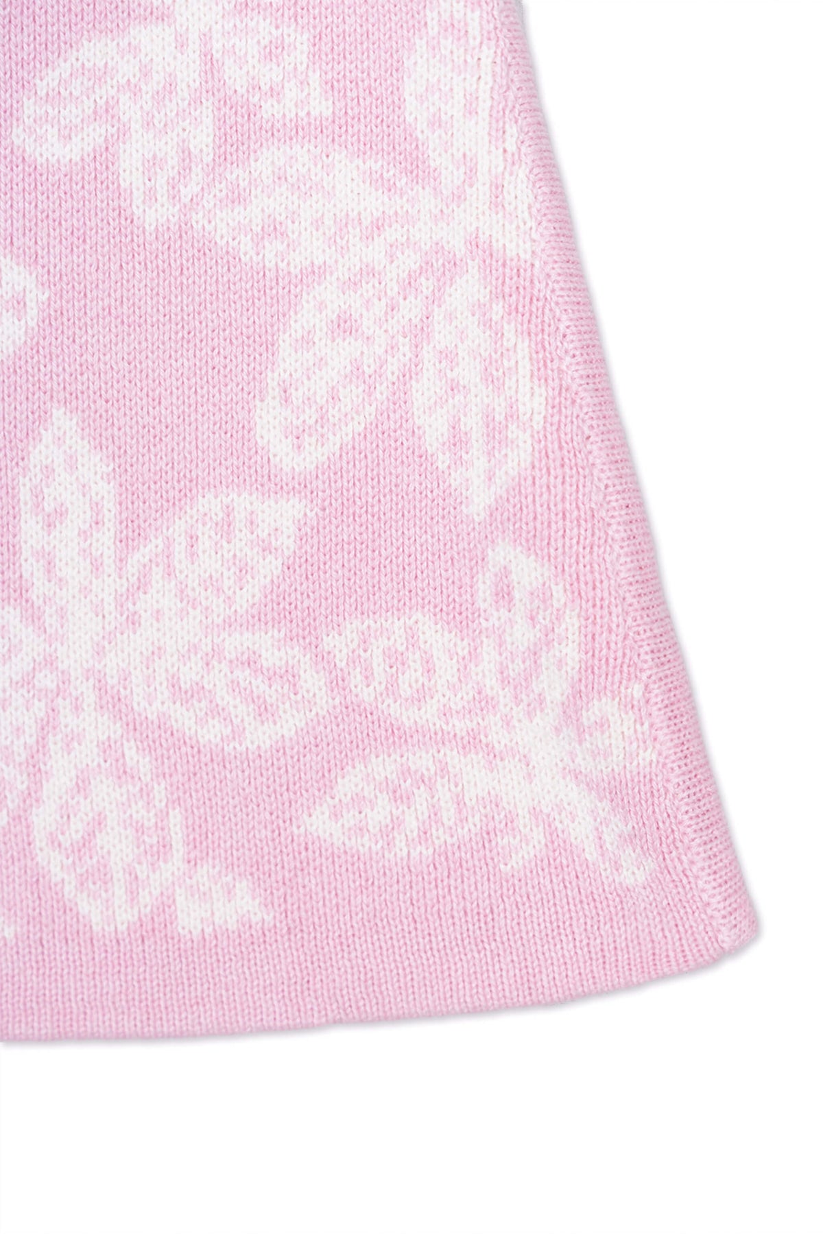 Close-up of the jacquard-knit chestnut leaves on the bubble gum pink skirt