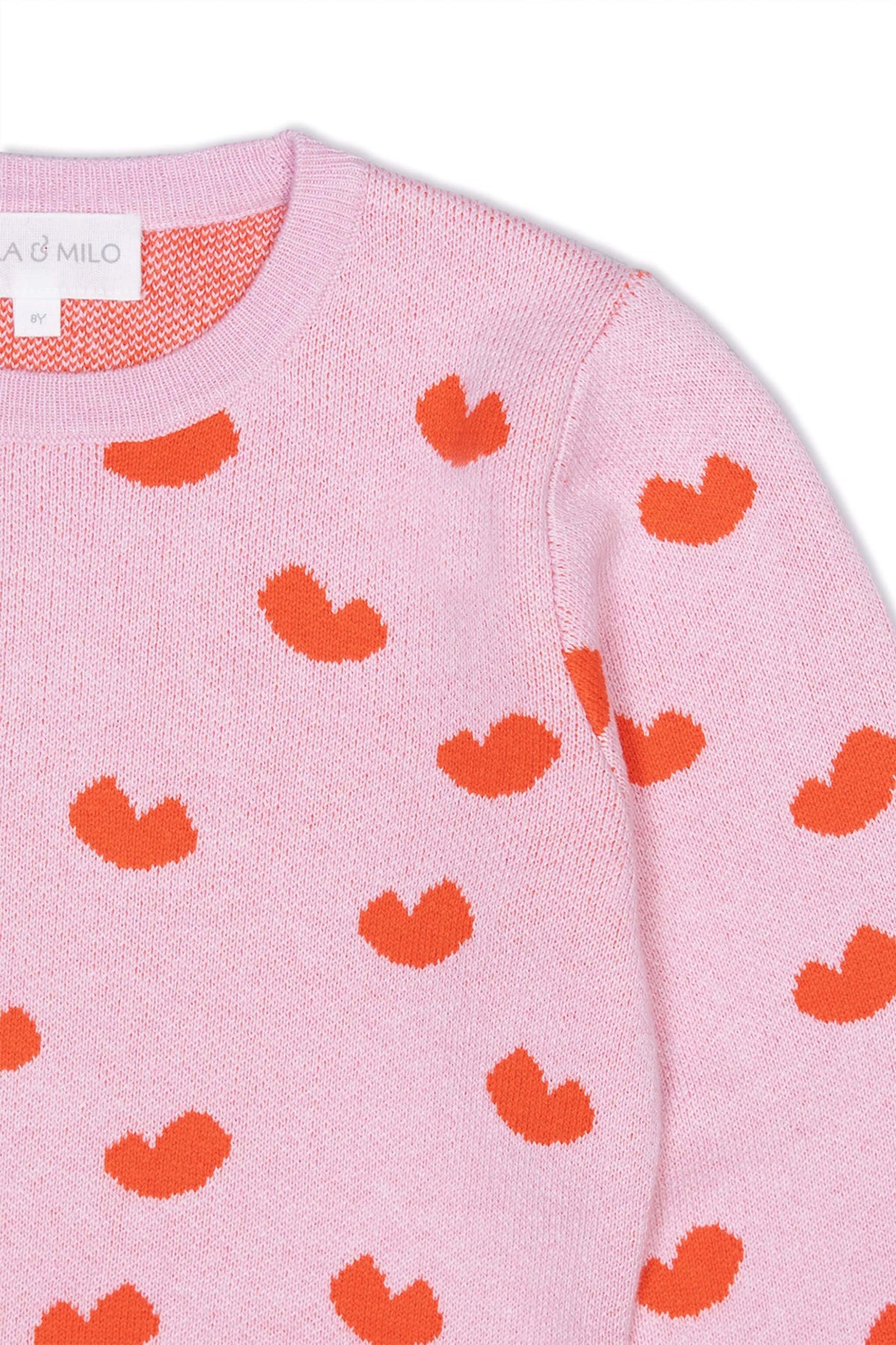 Close-up of the jacquard-knit hearts on the bubble gum pink dress