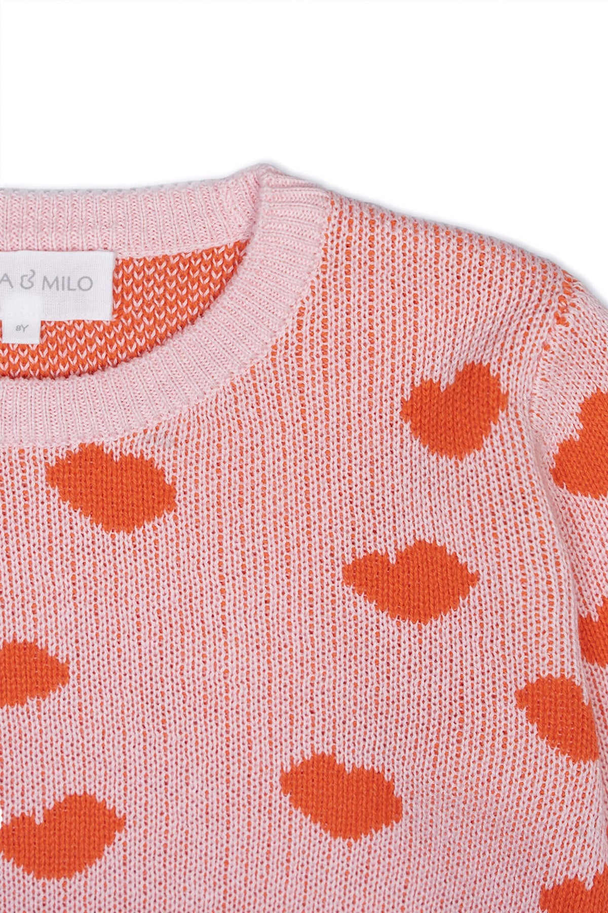 Close-up of the jacquard-knit hearts on the rose pink jumper
