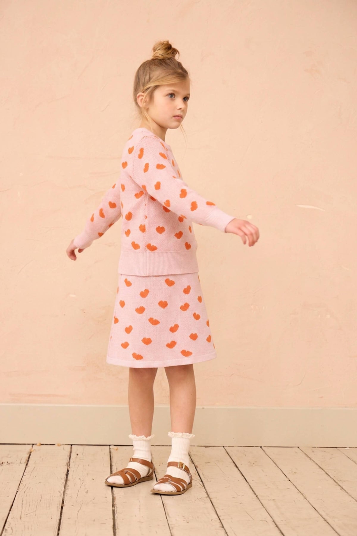 Girl wearing the MIKA & MILO Love Hearts Skirt with the matching jumper in rose pink