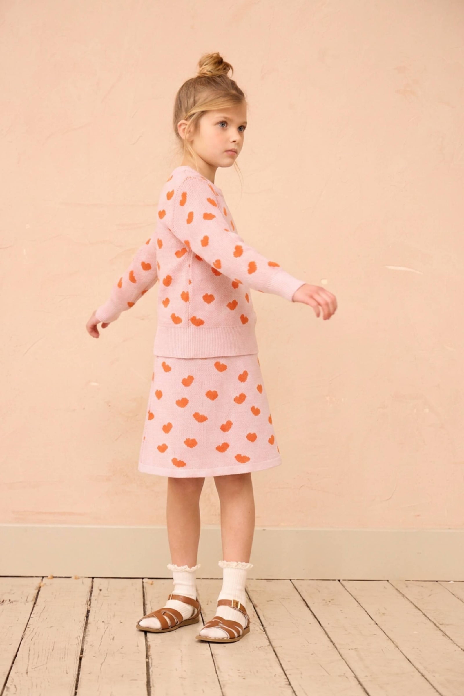Girl wearing the MIKA & MILO Love Hearts Skirt with the matching jumper in rose pink