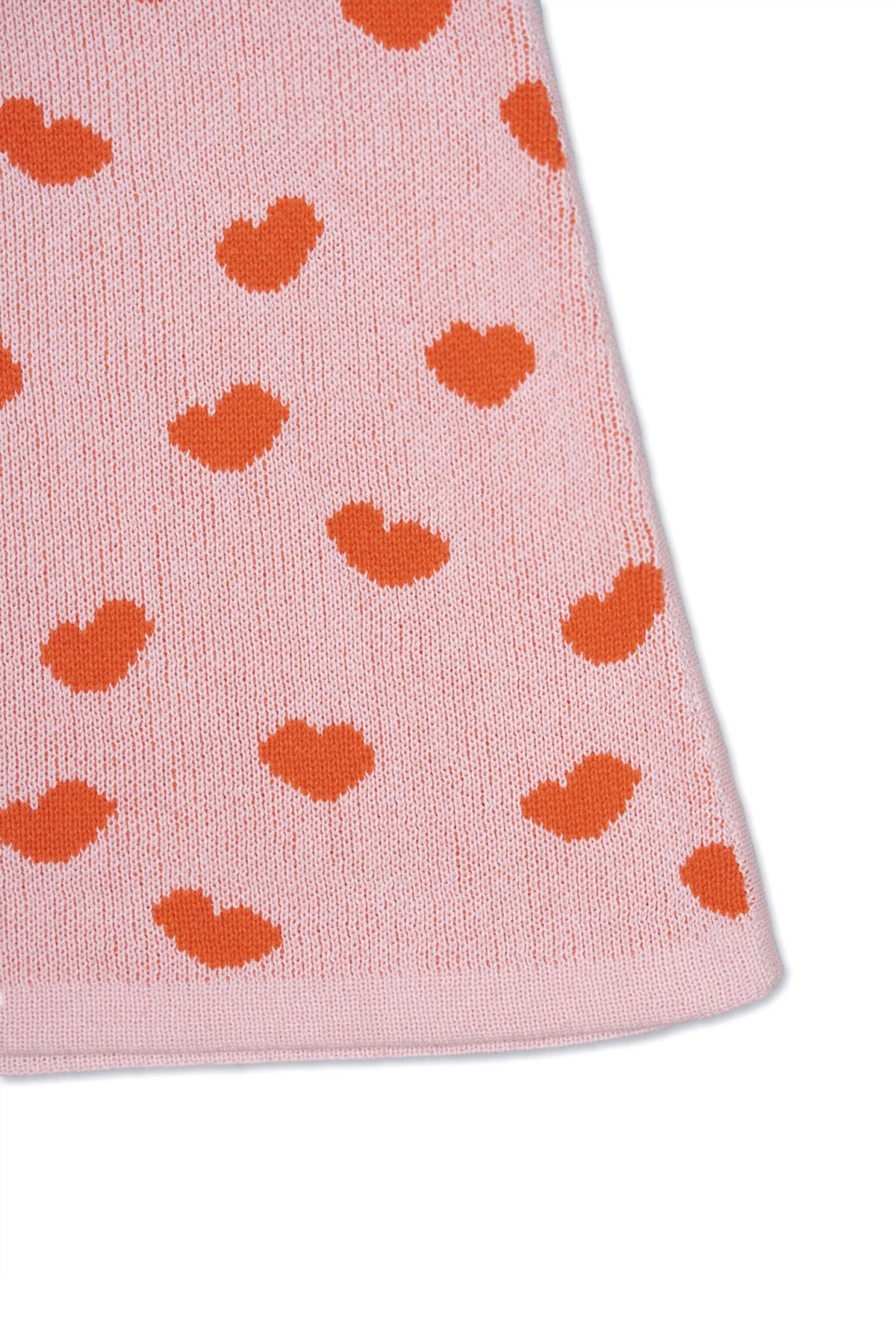 Close-up of the jacquard-knit hearts on the rose pink skirt