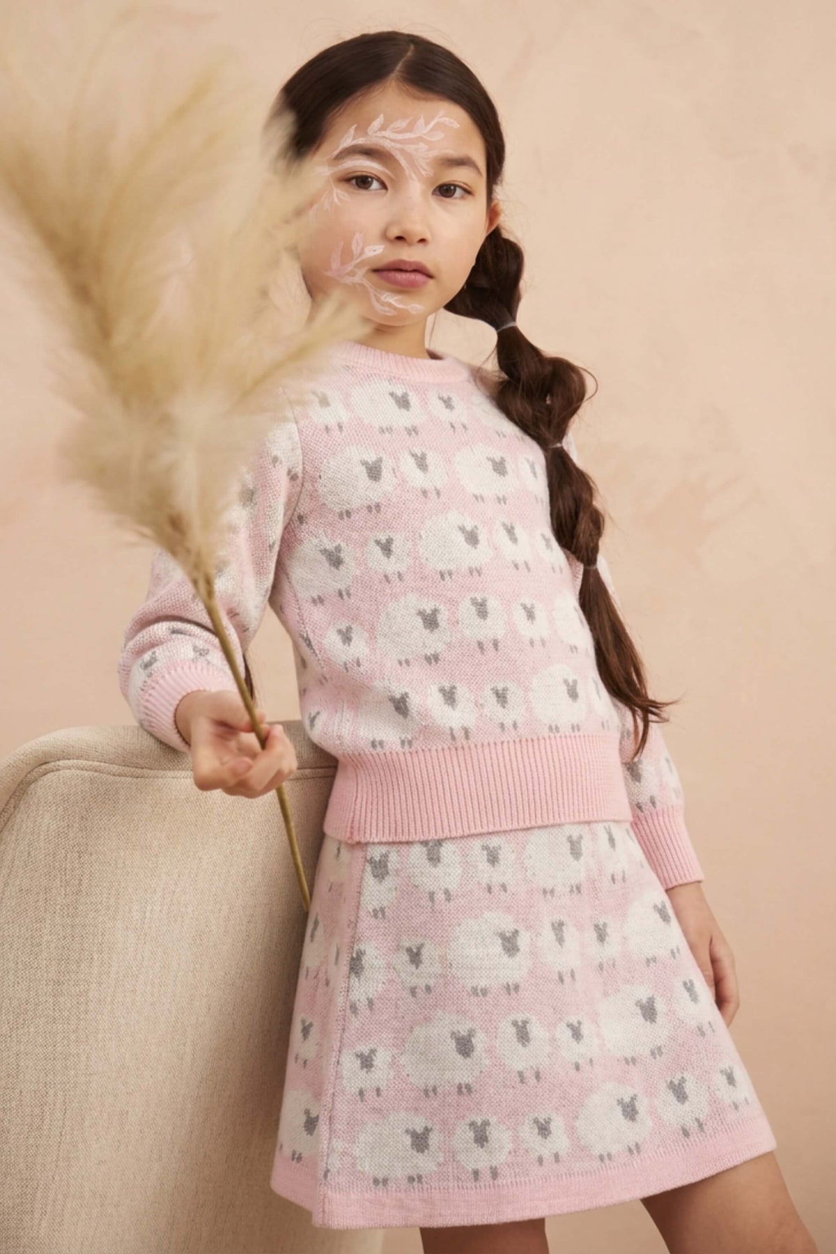 Girl wearing the MIKA & MILO Little Bo Peep jumper and skirt set in rose pink