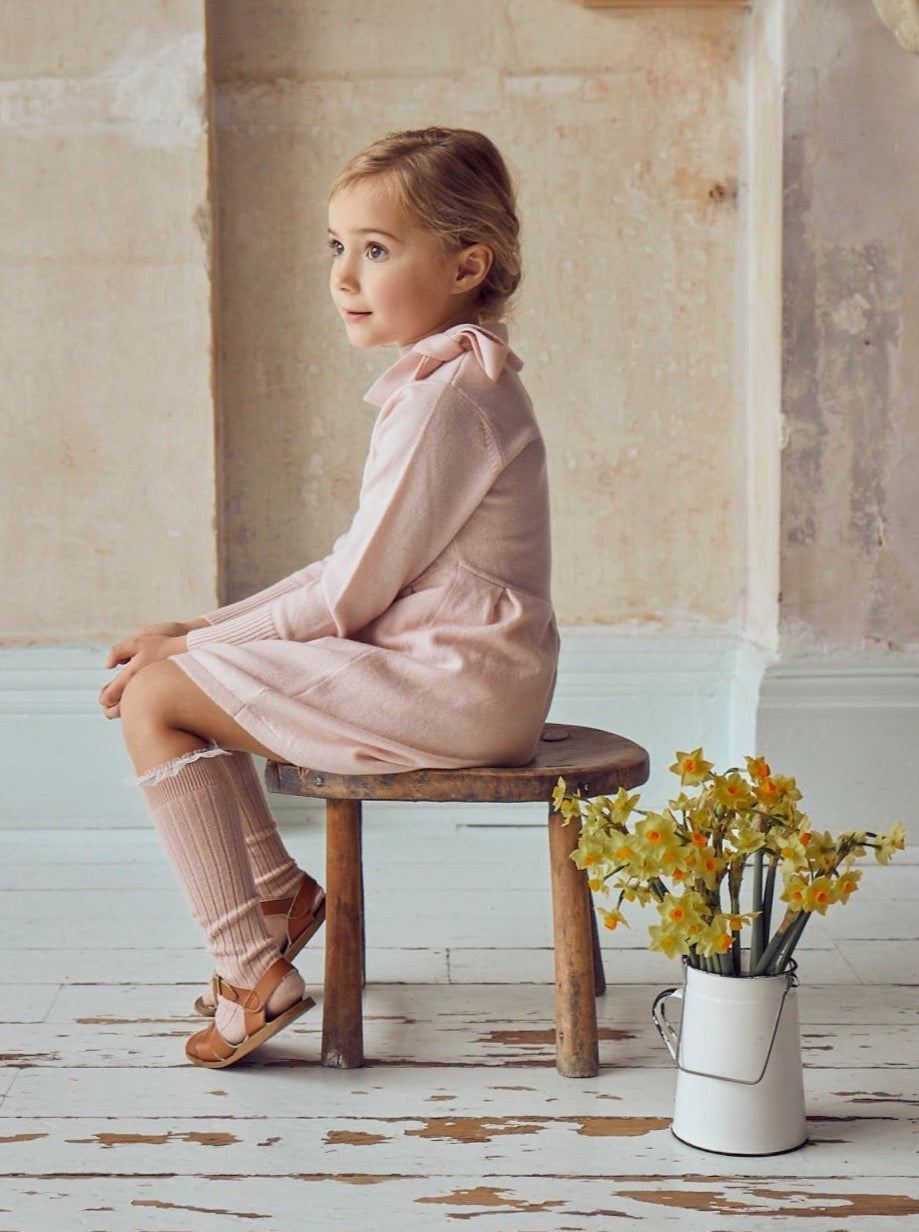 This timeless 2 ply dress in Blush Pink comes with a classic Pussy Bow. It also comes with Pleats at the waistline for added femininity. Made with the softest cashmere/ merino blend from Inner Mongolia, it will keep your Little One stylish and warm all winter long. 