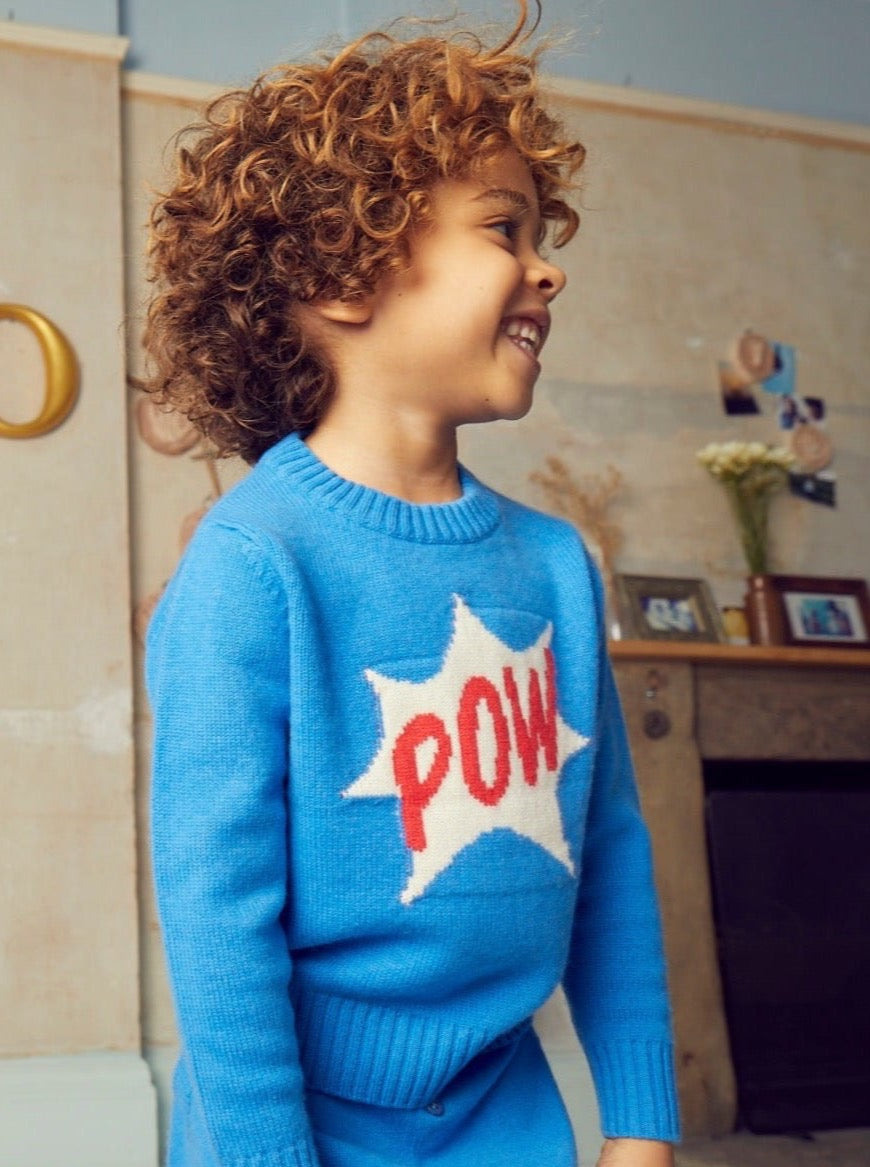 Bang, Crash, Thump: POW. This cosy 4 ply jumper comes with a double collar rib and POW emblazoned across the front super hero style. It will appeal to all young super heroes in the making.   Made with the softest cashmere/ merino blend from Inner Mongolia, it will keep you Little One cosy and warm all winter long.   Team it up with our matching Boy Pants in Bright Blue for a head-to-toe cosy feel. 