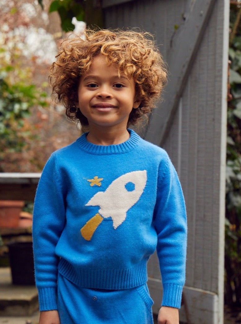 Zoom, zoom, zoom, we’re going to the moon. Jet off into space with our cosy little Rocket Jumper which will appeal to all young space lovers!  Made with the softest cashmere/ merino blend from Inner Mongolia, it will keep you Little One cosy and warm all winter long.   Team it up with our matching Boy Pants in Bright Blue for a head-to-toe cosy feel. 