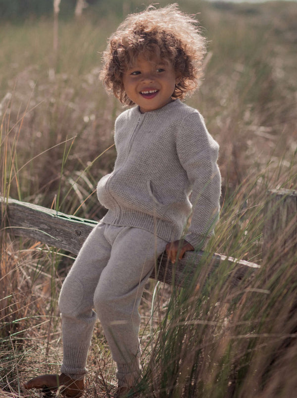 These cosy 2 ply pants in Grey come with knee pads for some boyish wear-and-tear, and fold up cuffs which can be lengthened as your Little One grows taller.  Made with pure cashmere from Inner Mongolia, they will keep your Little One stylish and warm all winter long.  Team them up with any of our Jumpers or Jackets for a head-to-toe cosy feel. 
